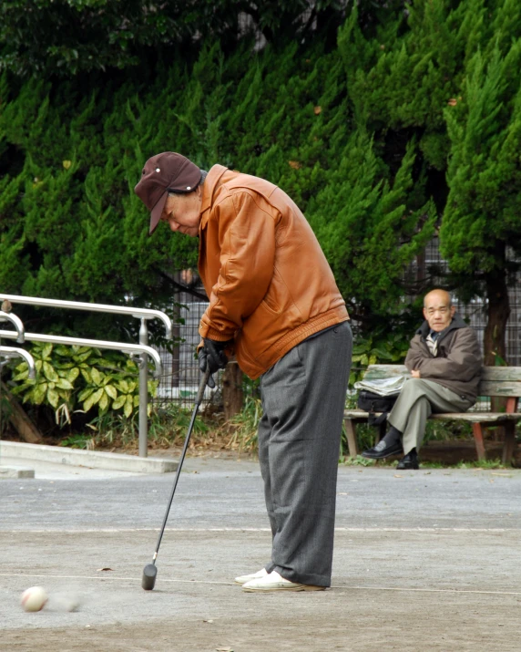 a man is playing golf on a bench