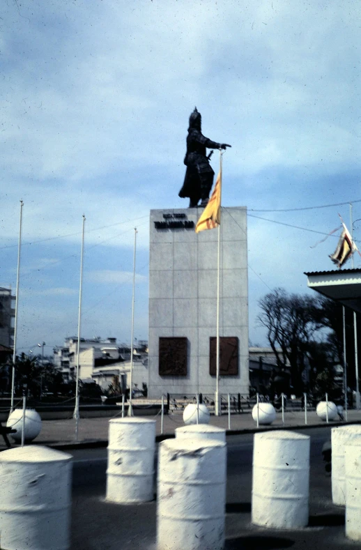 a monument with a woman holding a flag above it