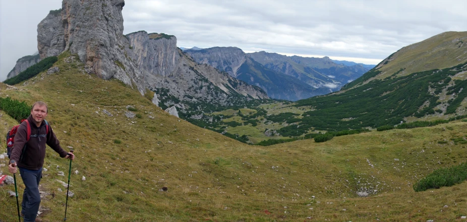 a man hiking on the side of a mountain