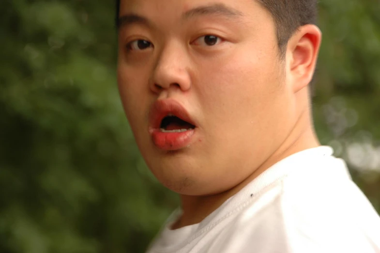 a young asian man wearing a white shirt