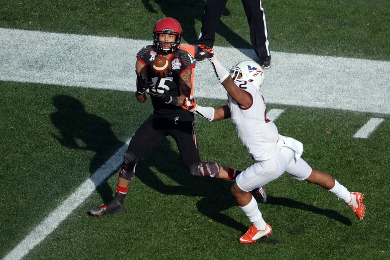 two football players fight for possession during a game