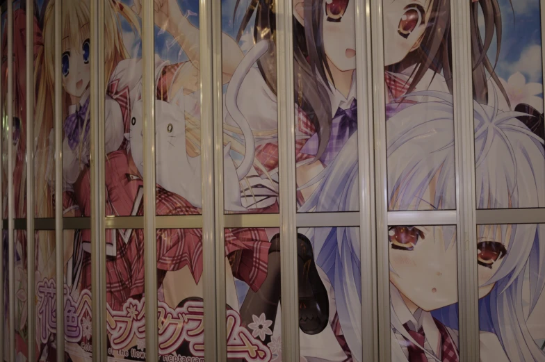 a group of anime posters on the wall of a building