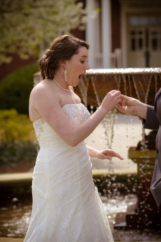 a woman is putting soing in her hand with a man's hand