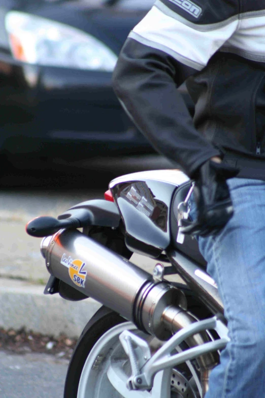 a man standing next to a motorcycle on a city street