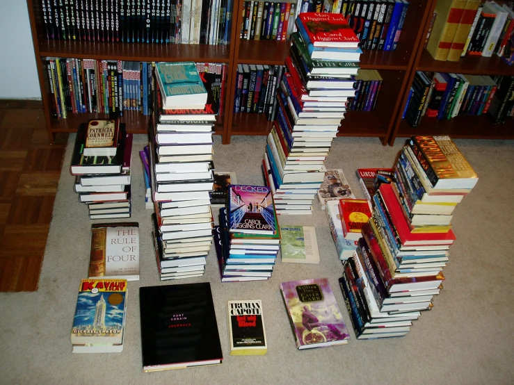 many books sitting on the floor next to each other