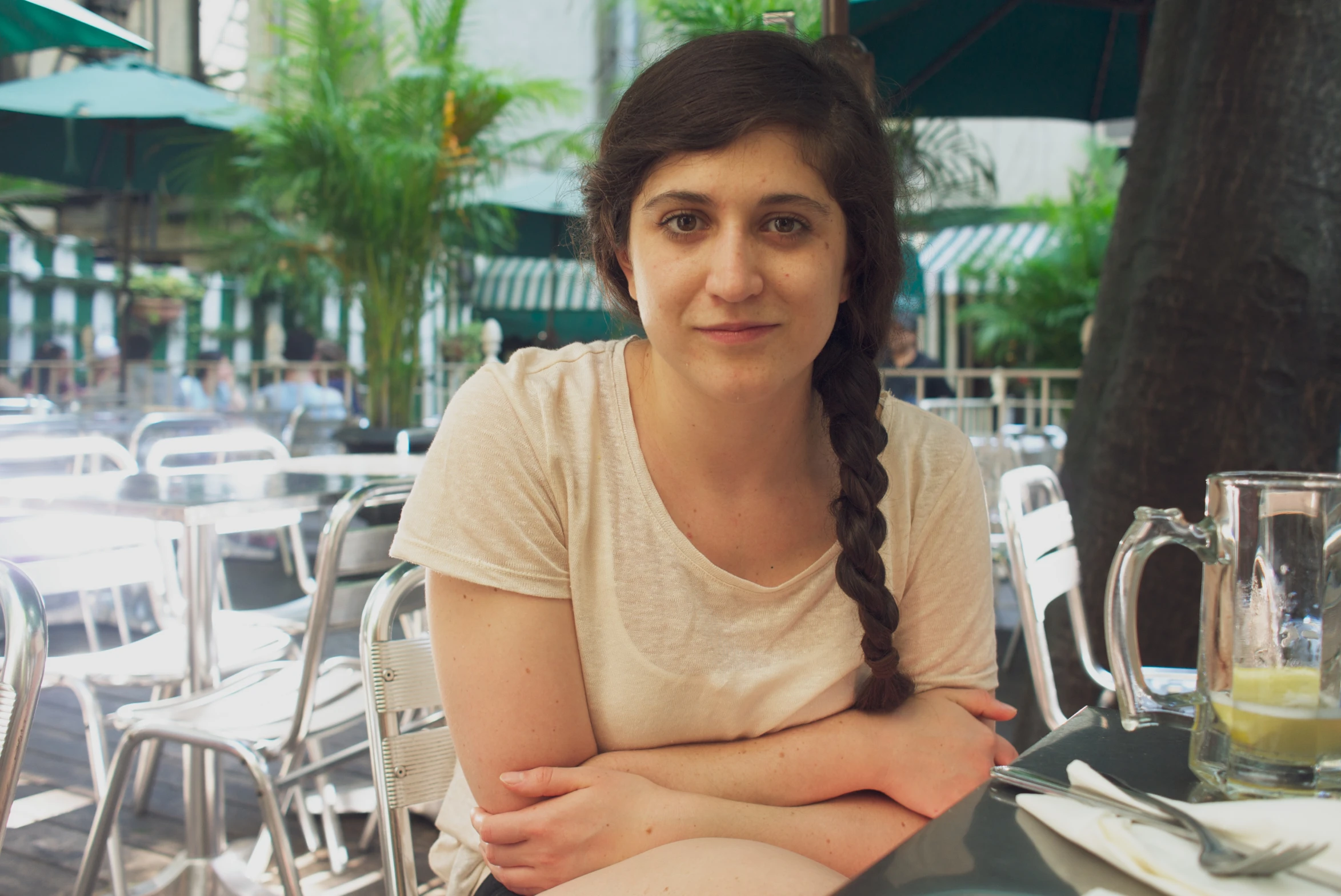 a woman sitting at an outside table with food