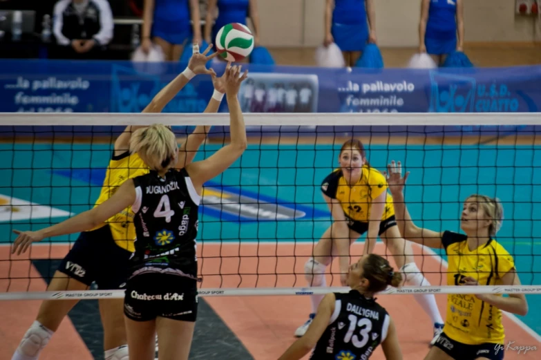 female volleyball players trying to block a ball