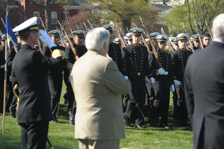 there are military men on a field with people in the background