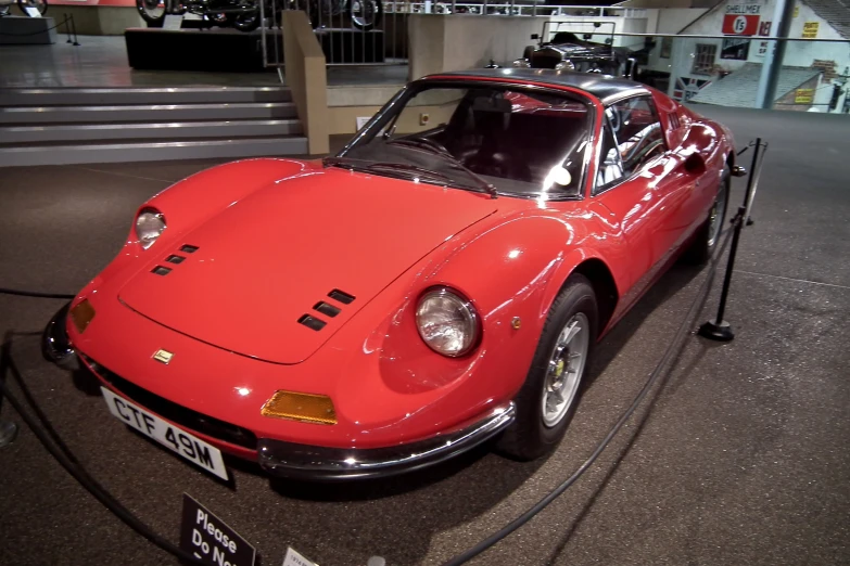 an old - fashioned sports car is on display in a museum