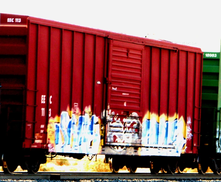 two trains with colorful boxes on the train tracks