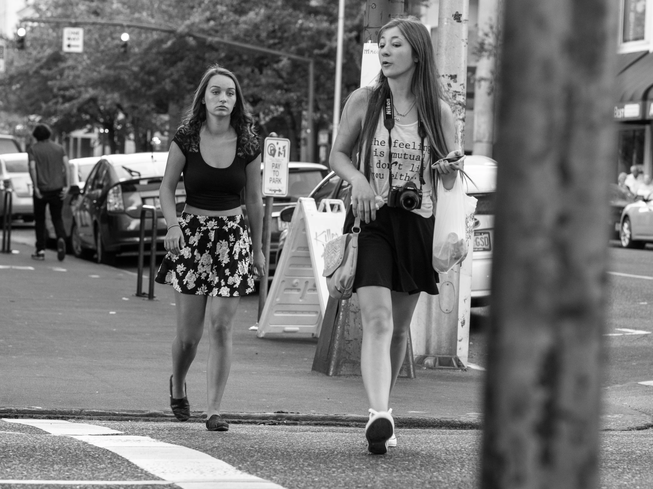 two beautiful young women walking down the street