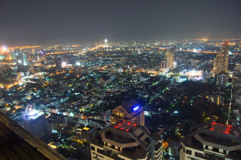 a cityscape view at night with a bright red light at the top