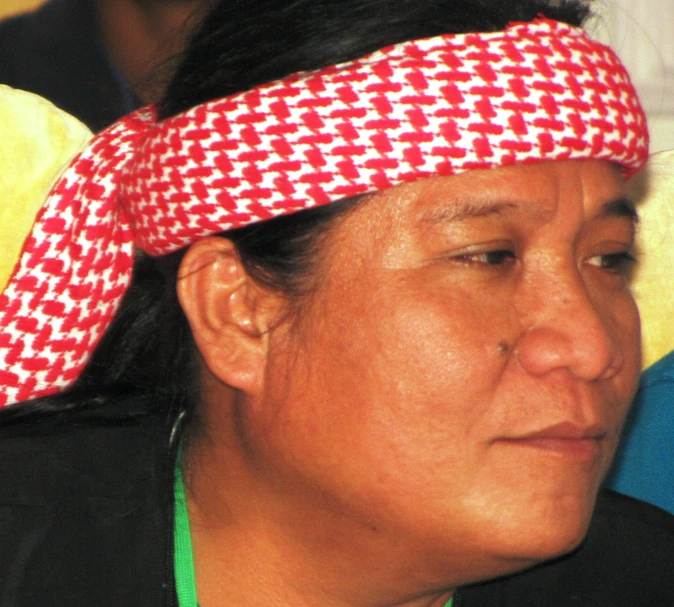 a lady with a red and white patterned bandanna over her head