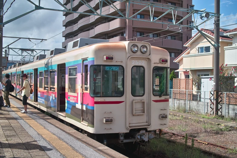 people are waiting at the station to board the train