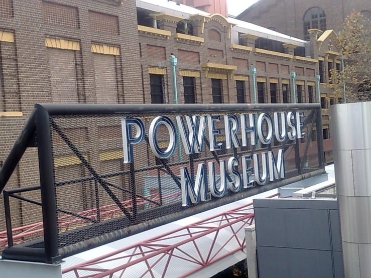 a building with brick and wire design and words on the side