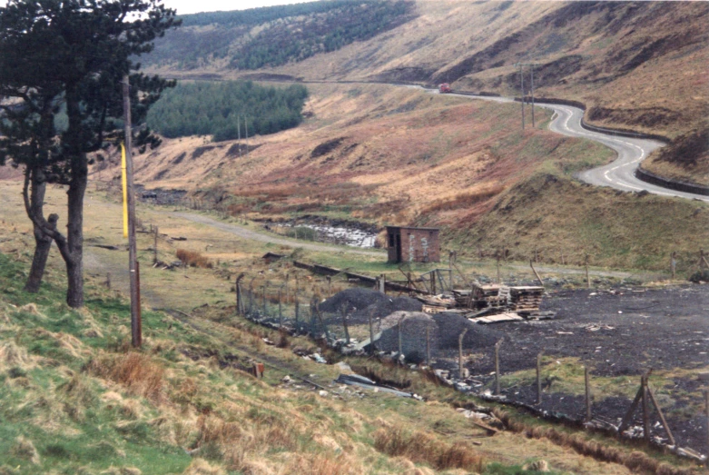 a very scenic and barren road and an old abandoned building in the countryside