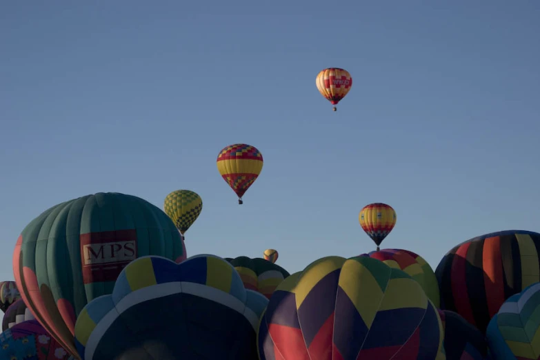 several  air balloons floating high in the sky