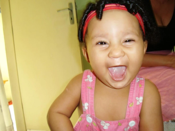 a little girl making faces and sticking out her tongue