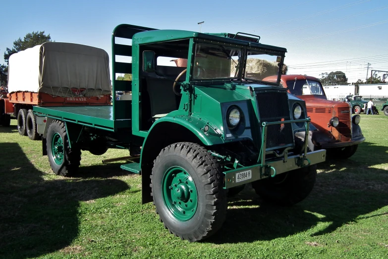 an old fashioned truck on display on the grass