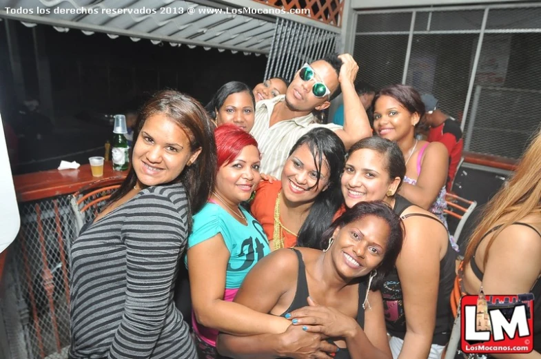 several women smile together while posing for the camera