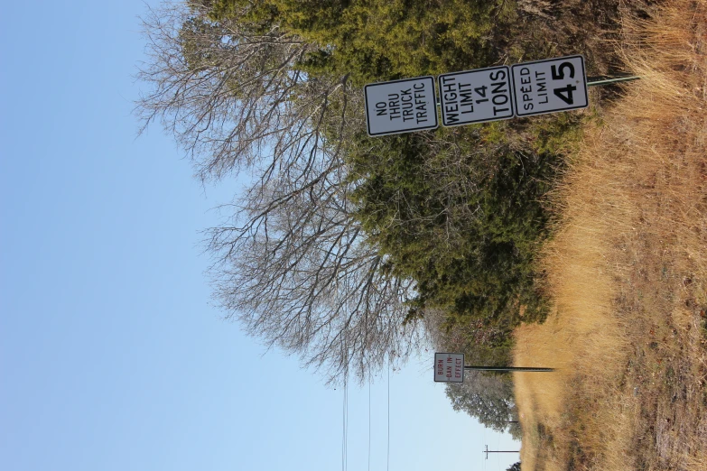 road signs at a rural country side near trees