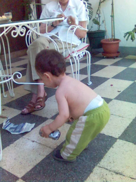 a small child looking at a piece of paper