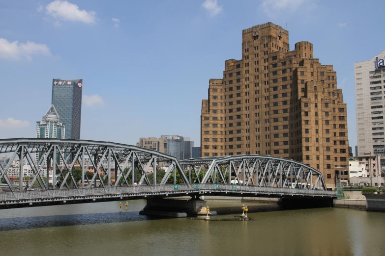a bridge over a body of water near tall buildings