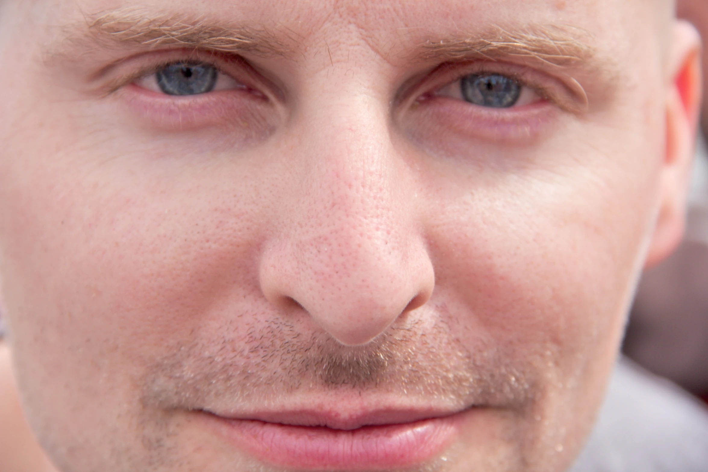 a closeup of a man with a toothbrush in his mouth