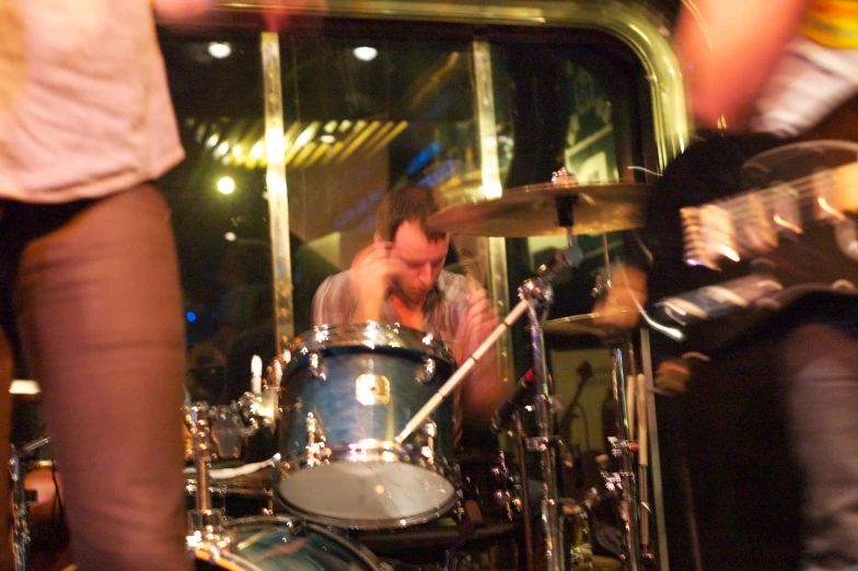a drummer plays with his drums near another drummer