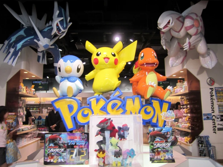 various stuffed animals in the shape of pokemons on display