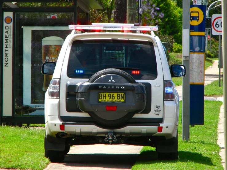 an suv has the rear wheel still attached and a light is on