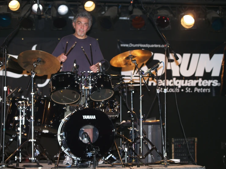 a man is playing drums on a stage