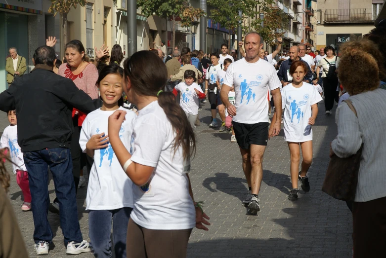 a man and girl are walking down the street together