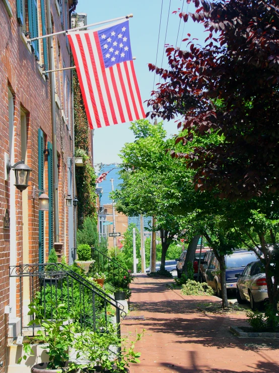 a united states flag on the side of an old brick building