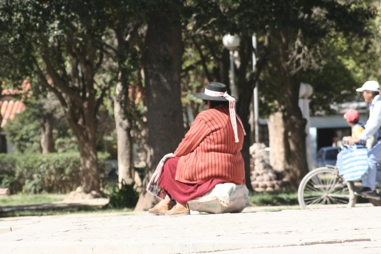 the lady has on her red robe and white hat