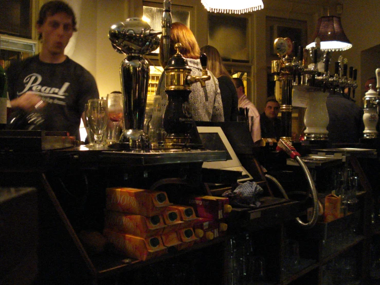 people standing around in front of a bar counter