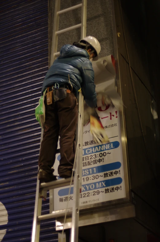 a man that is standing on a ladder