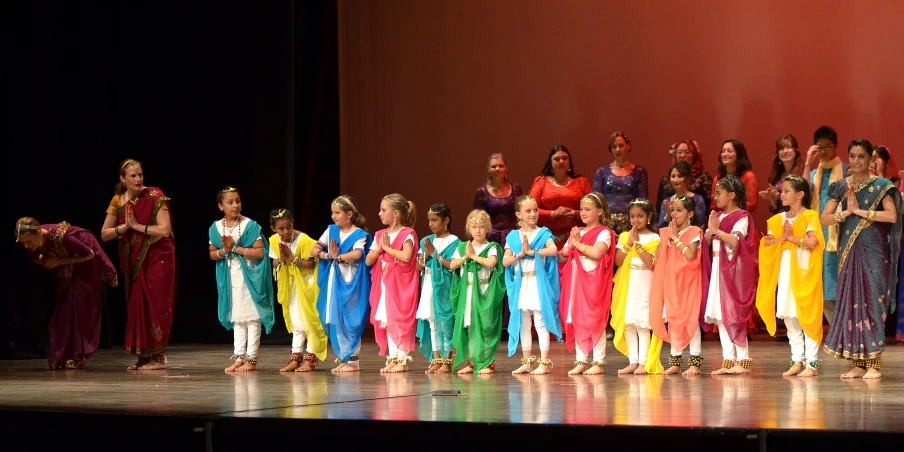 an image of girls in a costume standing together on stage