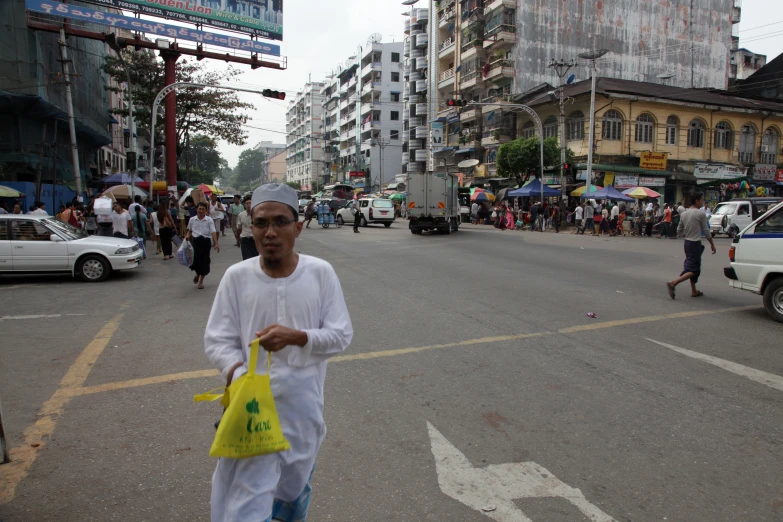 a man carrying a bag down the street