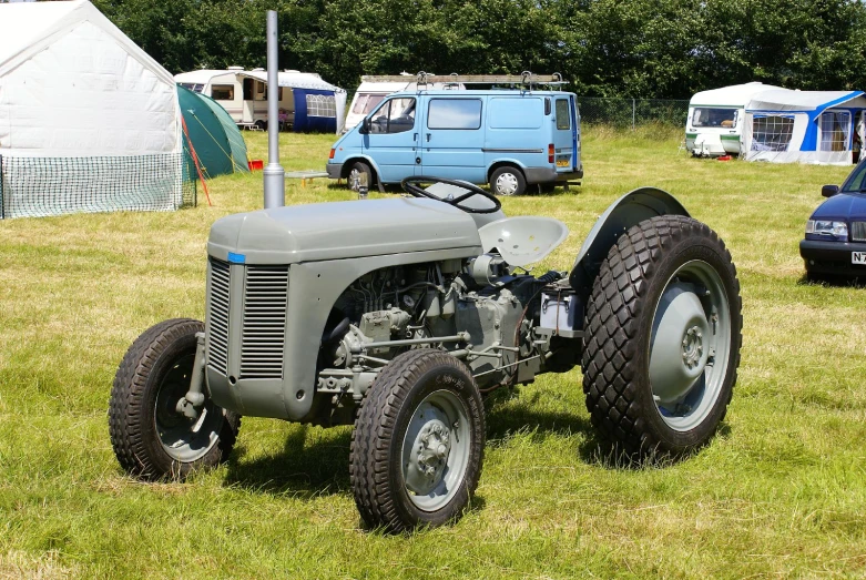 an old tractor sits alone in a field