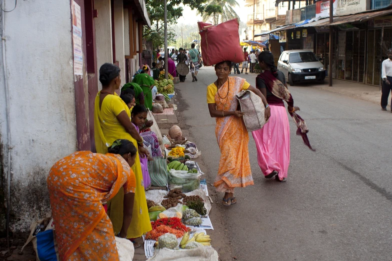 people standing in front of tables covered with food