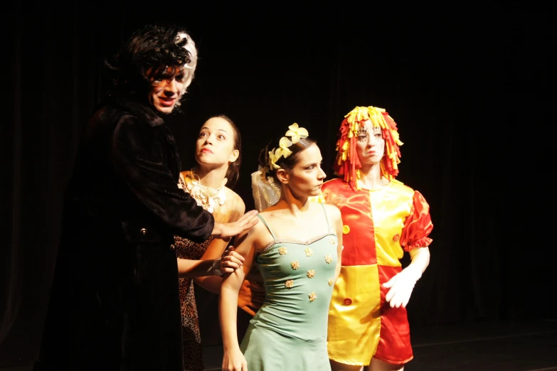 a group of young people in costume performing on stage