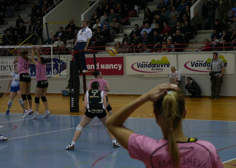 several female volleyball players competing in a game
