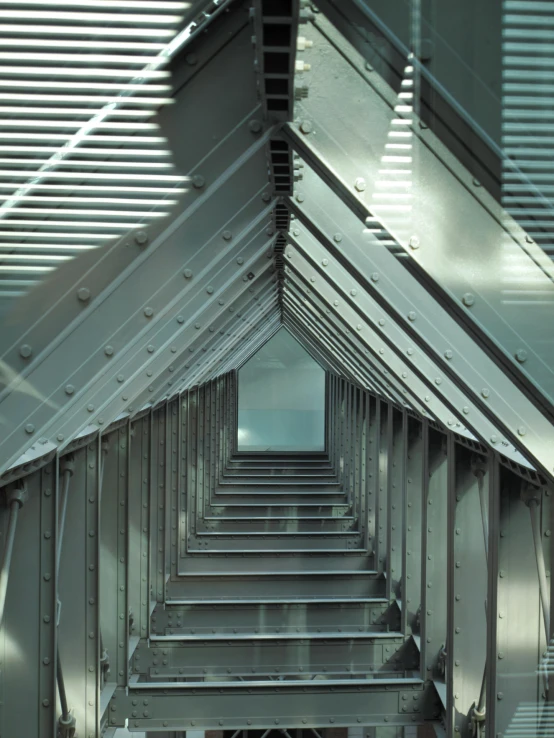 a building with the roof and many lights coming in from the windows