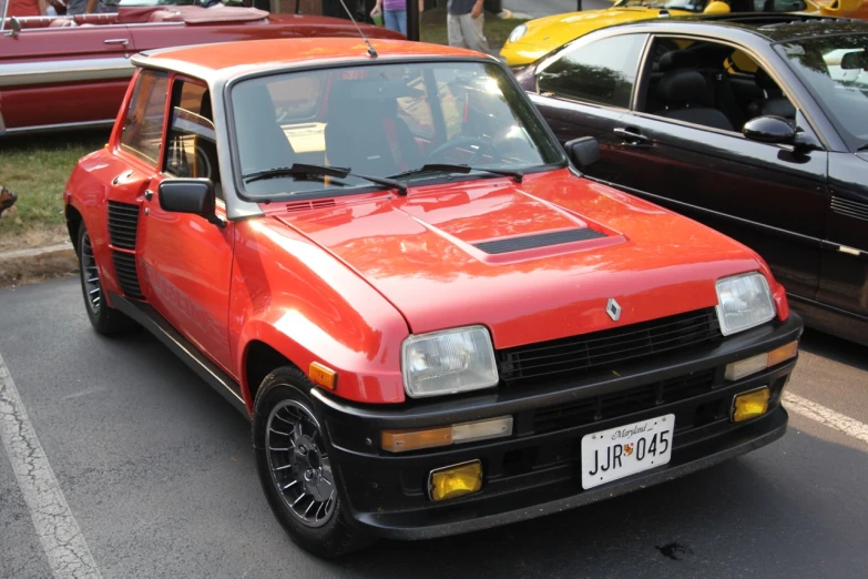 a red car is parked in a parking lot