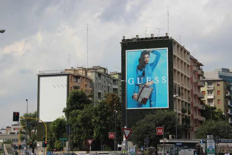 a large advertit is being displayed on the side of a tall building