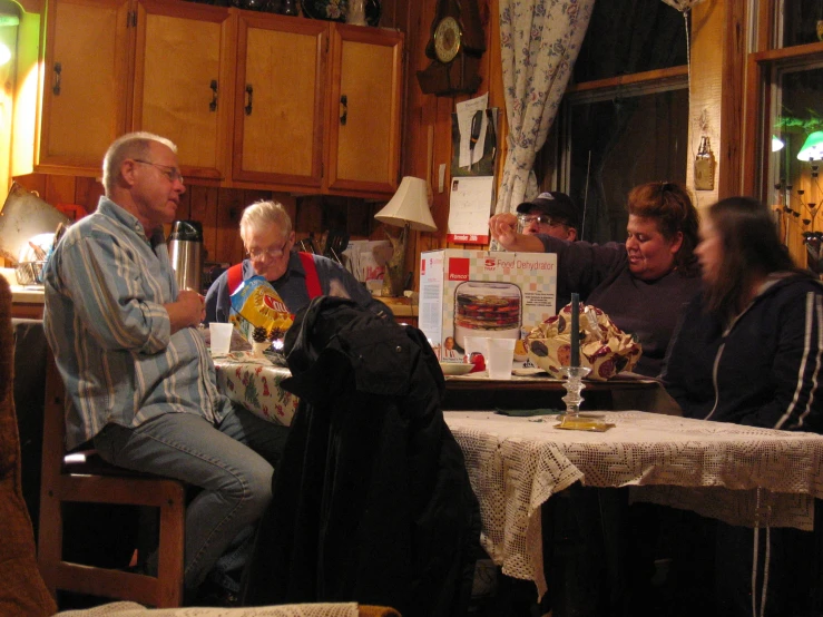 people at a dinner table eating and drinking