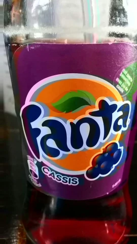a purple jar that is filled with a candy drink