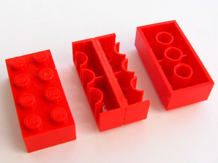 a couple of red lego blocks sitting on top of a table