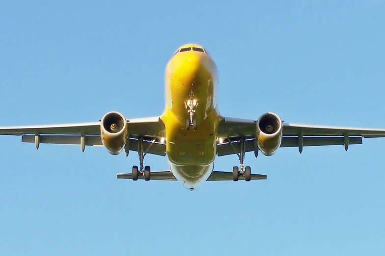 an airplane is flying in a blue sky